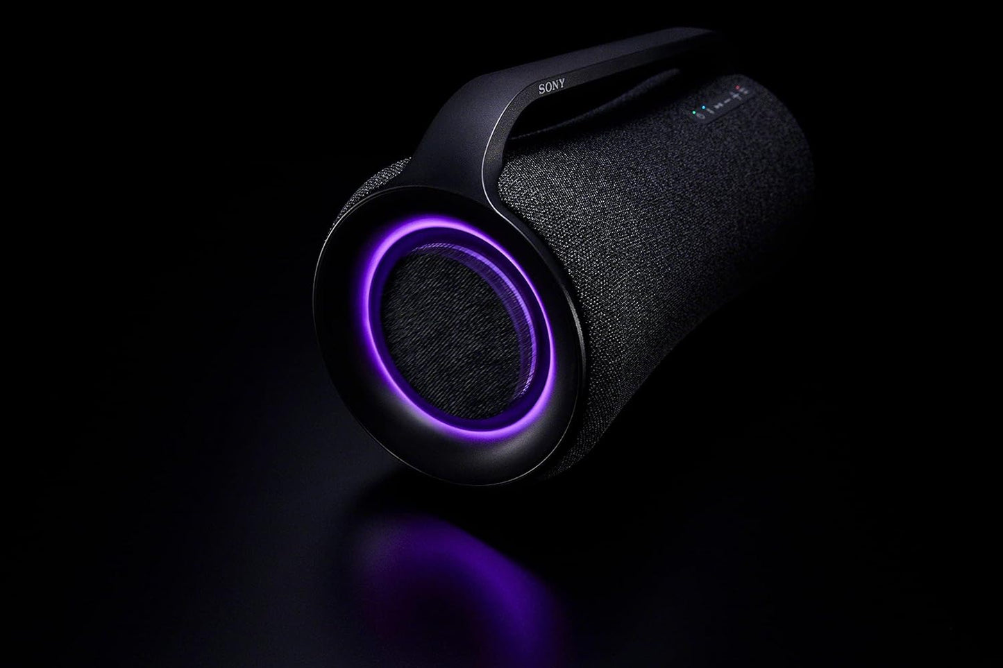 Sony SRS-XG500 speaker at a lively outdoor party, highlighting its rugged, IP66-rated design and dynamic LED lighting effects.