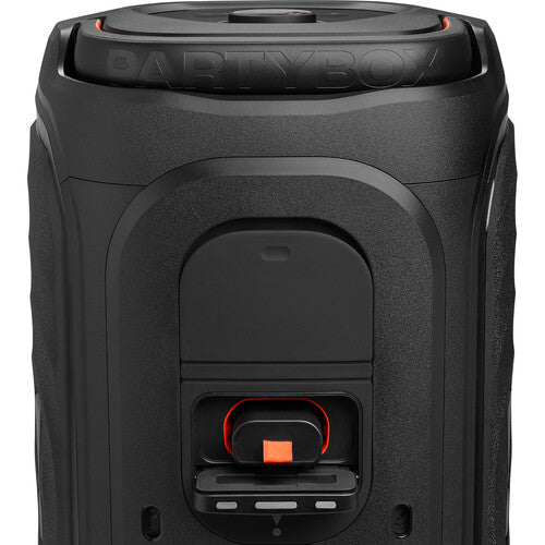 JBL PartyBox 130 Kenya rear close-up showing PartyBox embossed top lid and orange-accented battery compartment door`
