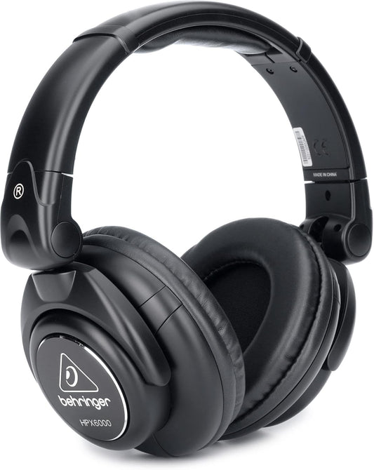 Behringer HPX6000 professional DJ headphones showing over-ear cups and adjustable headband against a white background.