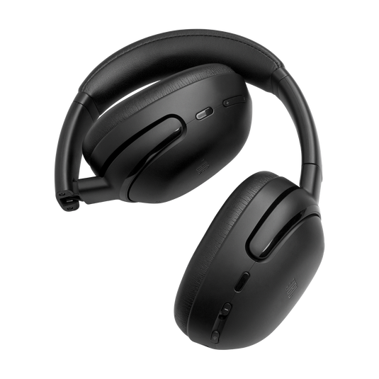 Black JBL Tour One M3 over-ear headphones resting on their folding hinge, earcups showing plush memory-foam cushions.