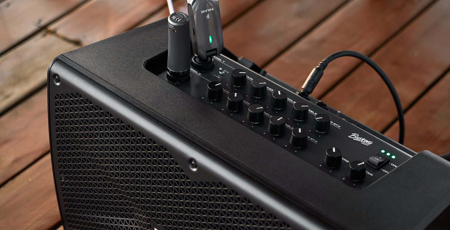 NUX Busking 200FR PA Kenya top panel on wooden deck with wireless receiver in Ch1 and cable in Ch2
