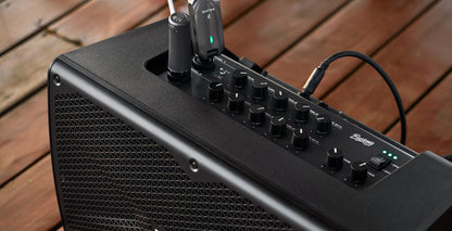 NUX Busking 200FR PA Kenya top panel on wooden deck with wireless receiver in Ch1 and cable in Ch2