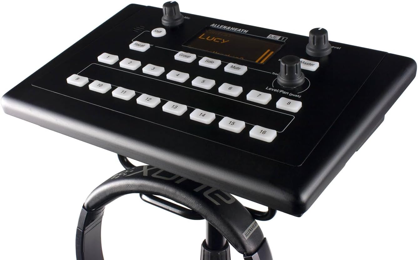 Allen Heath ME-1 Kenya mounted on mic stand with headphones below, OLED display reading Lucy, top-down angle