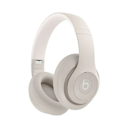 Beats Studio Pro Kenya over-ear wireless headphones in sand beige colorway, front 3/4 view on white background