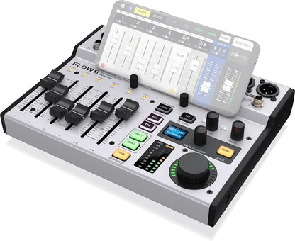 Behringer FLOW 8 Kenya 3/4 front view with FLOW Mix app displayed on smartphone resting on top of mixer