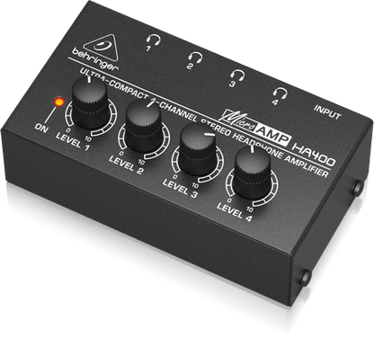 Behringer HA400 headphone amplifier Kenya connected to laptop with studio headphones plugged into TRS output jack