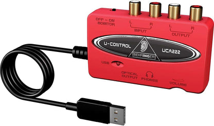 Behringer UCA222 Kenya front view showing RCA input output ports, USB cable, optical output and phones volume control