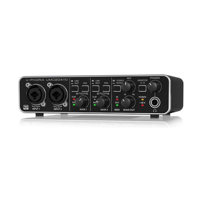 Behringer UMC204HD Kenya — angled front-left view on reflective surface showing full front panel and unit depth