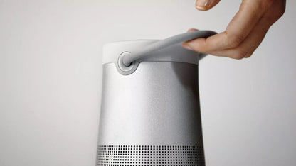 Bose SoundLink Revolve+ II Kenya — hand gripping the Luxe Silver fabric handle, close-up carry view