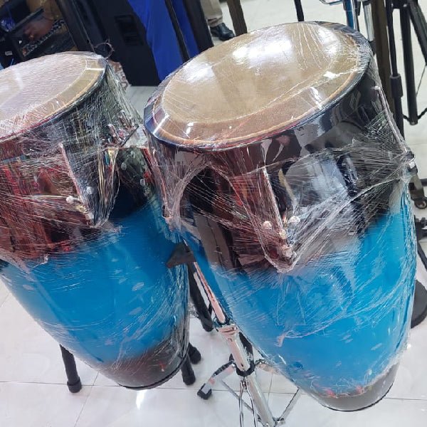 DC conga drums Kenya — two drums in blue finish, still in protective wrap, mounted on stands, front angle view