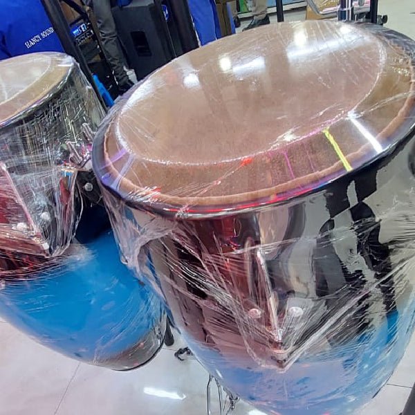 DC conga drums Kenya — close-up top angle of large tumbadora drum in dark finish, natural skin head, protective wrap on