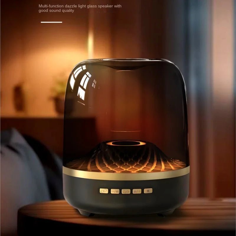 Glass Bluetooth Speaker Kenya Glass5+ black unit on wooden surface showing warm ambient glow through glass shell