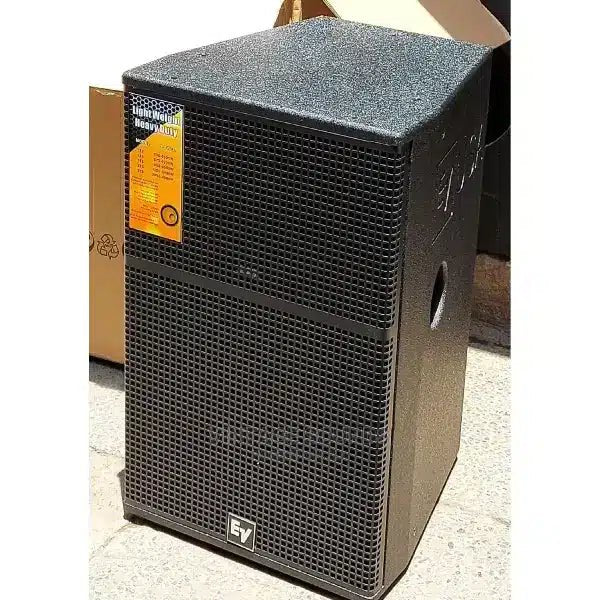 Electro-Voice DS115 Kenya 15" passive PA speaker front 3/4 view with EV logo, mesh grille, in-box unboxing context