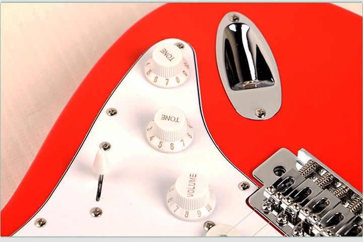 Fender passive lead guitar Kenya red body closeup showing tone and volume knobs, white scratchplate and chrome tremolo cover