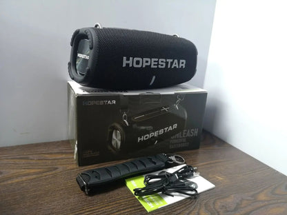 HOPESTAR H50 50W Bluetooth Speaker Kenya black unit unboxed with microphone, cables, manual and retail box on wooden surface