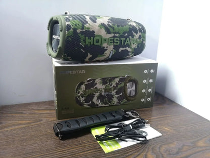 HOPESTAR H50 50W Bluetooth Speaker Kenya camouflage unit unboxed with microphone, cables, manual and retail box on wooden surface
