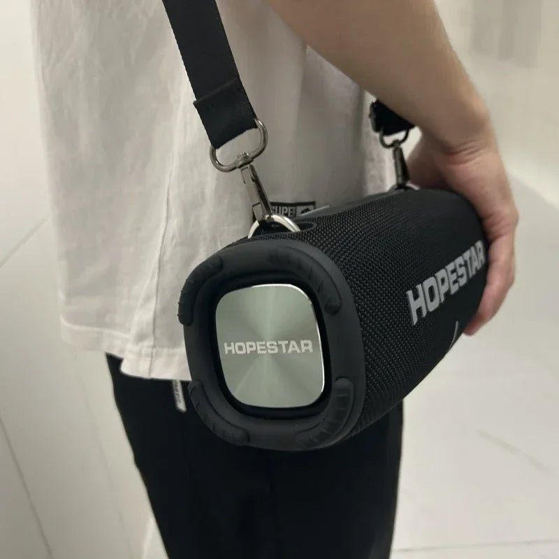 HOPESTAR H50 50W Bluetooth Speaker Kenya black unit worn on shoulder strap showing side speaker driver and HOPESTAR branding
