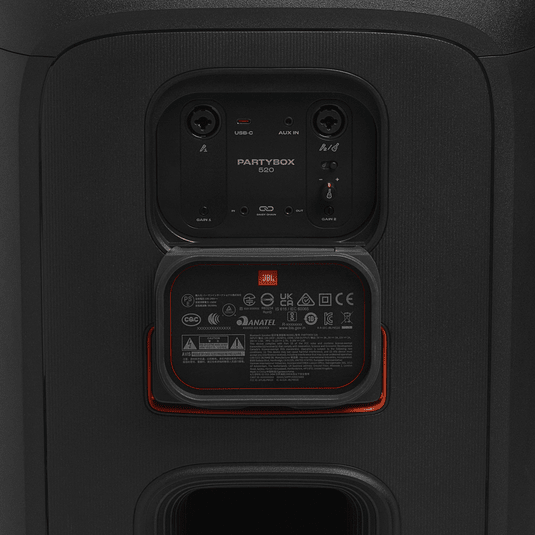 JBL PartyBox 520 Kenya close-up of swappable battery compartment with orange indicator and input port recess