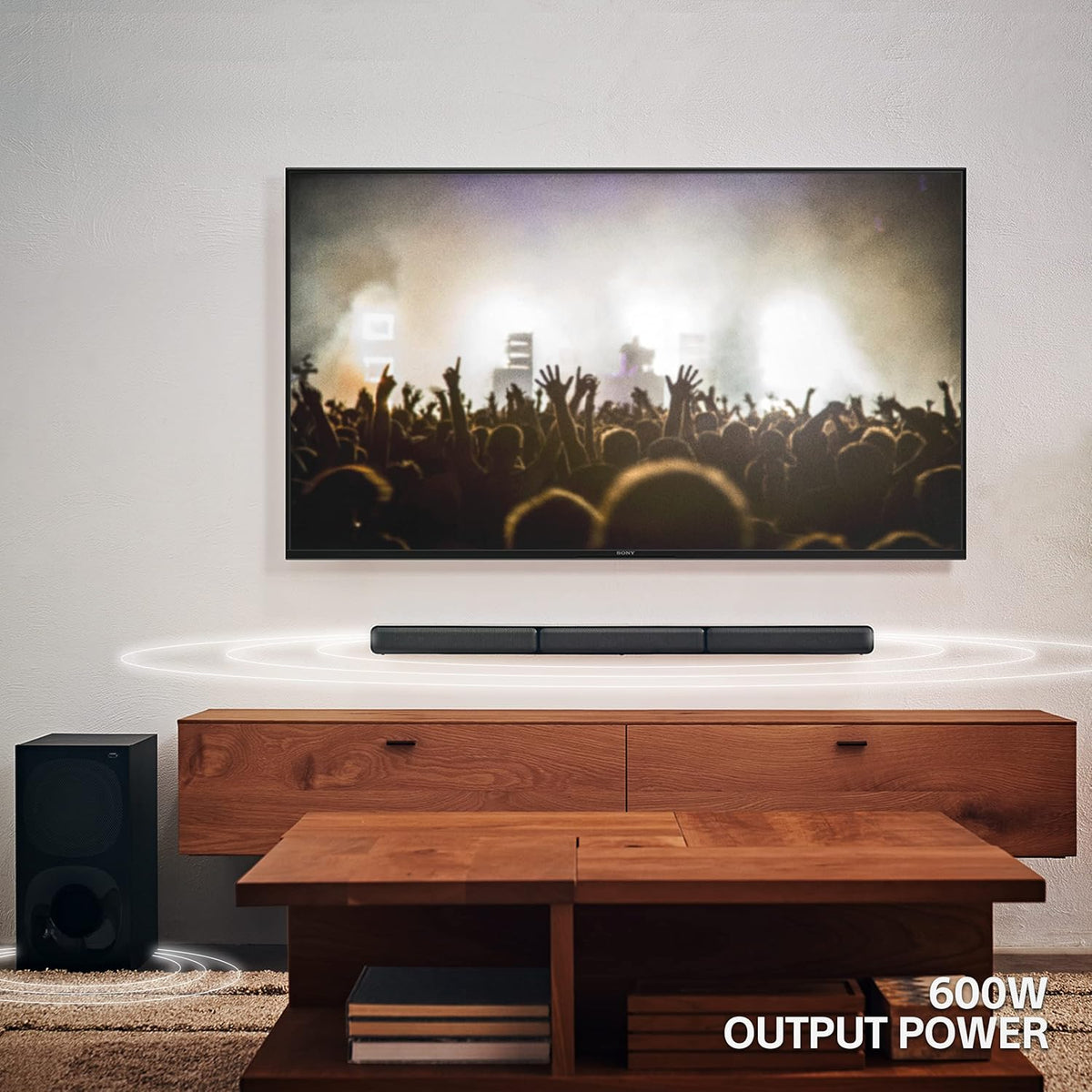 Sony HT-S40R home theatre Kenya — soundbar below wall-mounted TV with subwoofer on floor, 600W output power lifestyle shot