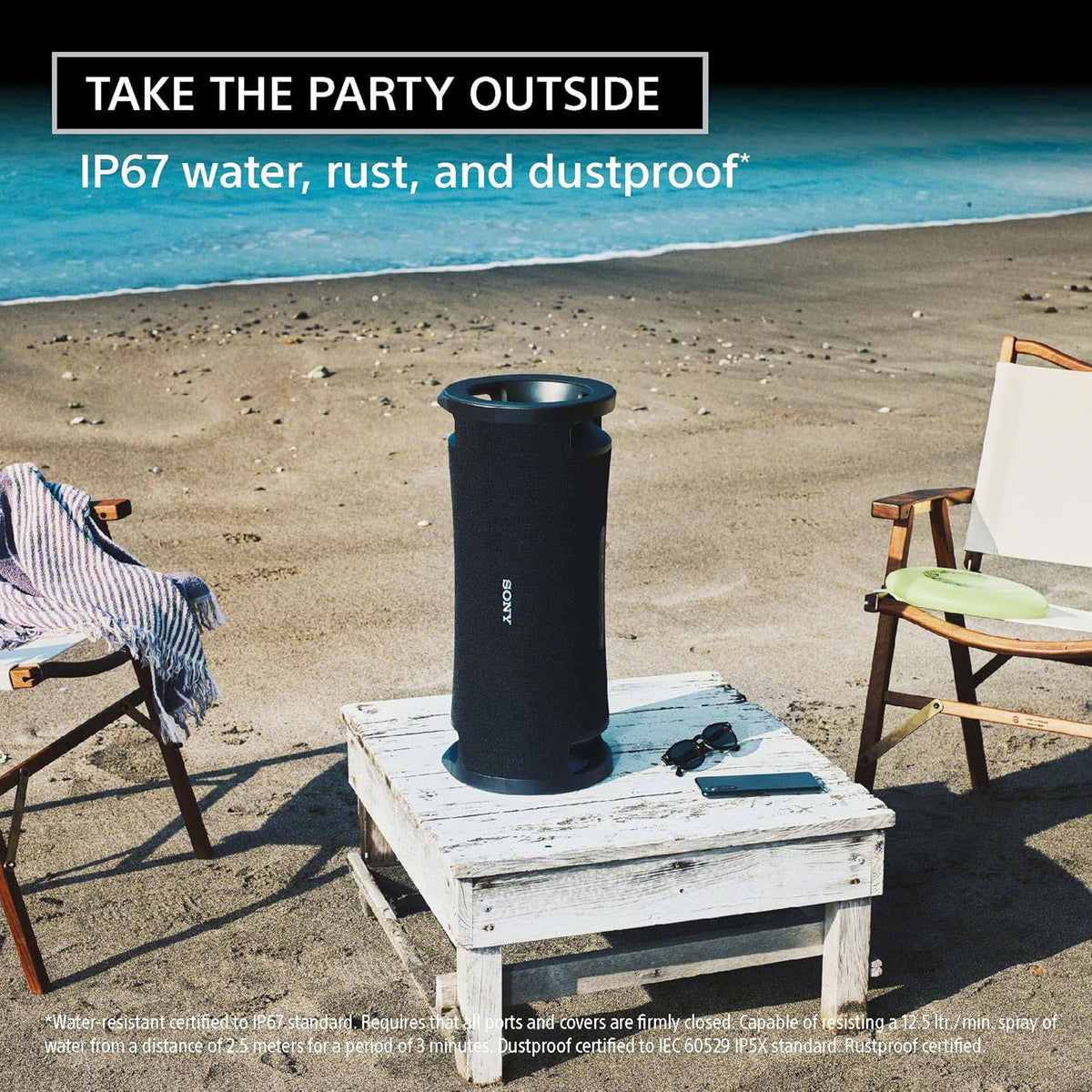 Sony ULT Field 7 Kenya standing upright on beach table outdoors, IP67 waterproof lifestyle shot with ocean backdrop