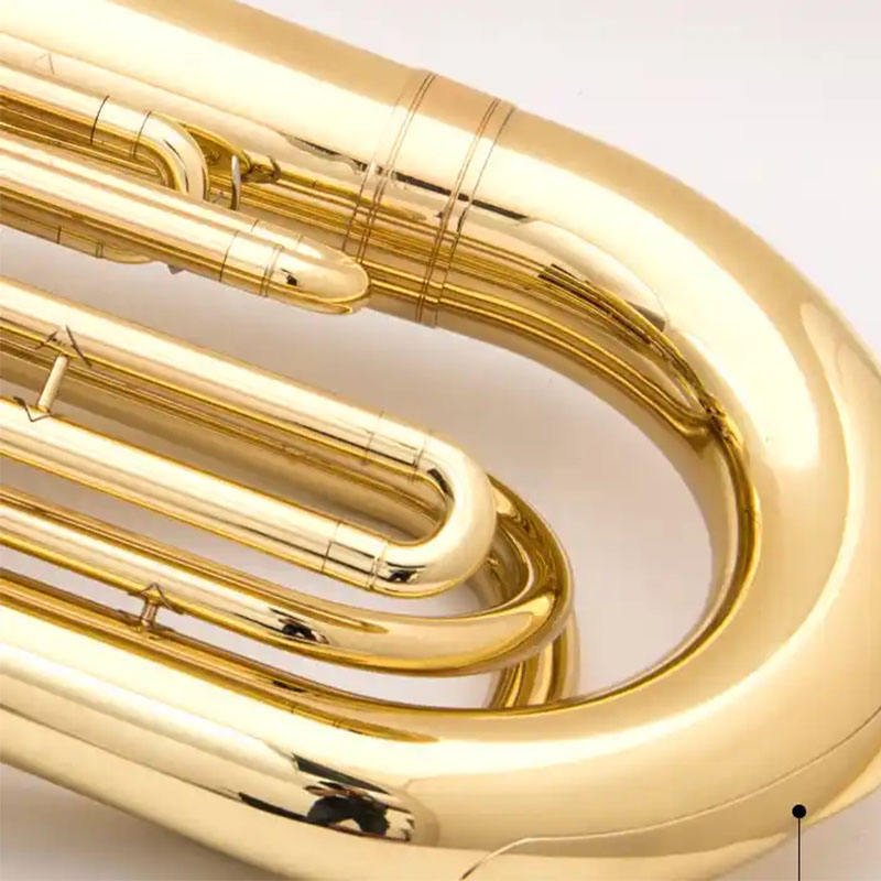 Close-up of tuba brass instrument rotary valve cluster and tubing detail, silver finish