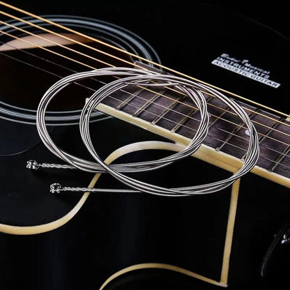 Ziko bass guitar strings Kenya – nickel wound strings coiled on electric bass guitar fretboard`